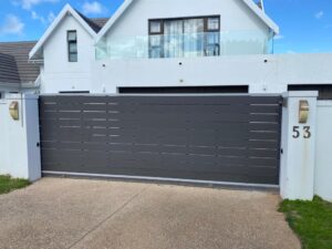 Dark grey Mecofence WPC electric sliding gate, providing secure, automated driveway access solutions for global residential constructors and wholesalers.
