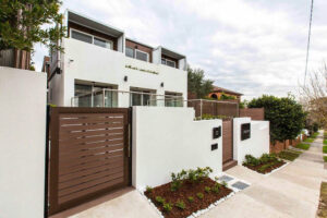 Solid dark grey Mecofence WPC pedestrian fence gate with a metal frame, providing secure, low-maintenance access solutions for residential constructors globally.
