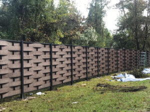Brown Mecofence woven WPC fence during installation, providing wind-resistant and durable boundary solutions for rural residential constructors globally.