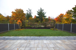 Dark grey Mecofence WPC boundary fence paired with mesh for scenic backyards, providing mixed-material solutions for overseas residential constructors.