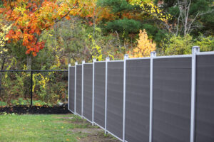 Dark grey Mecofence WPC stepped privacy fence, providing adaptable uneven terrain boundary solutions for overseas residential constructors.