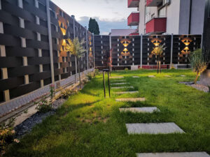 Black Mecofence woven WPC fence featuring integrated lighting, offering modern, low-maintenance boundary solutions for global residential constructors.