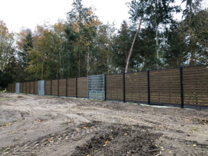 Brown Mecofence WPC and mesh perimeter fence, offering durable, large-scale boundary solutions for rural commercial constructors globally.