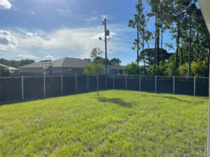 Dark grey Mecofence WPC semi-privacy fence with a slatted top, offering scalable and low-maintenance boundary solutions for suburban constructors globally.