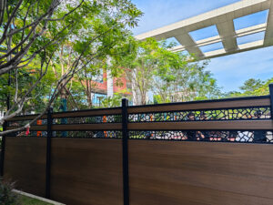 6ft Brown Mecofence WPC fence with custom decorative metal panels, delivering stylish, low-maintenance boundary solutions for global commercial developers.