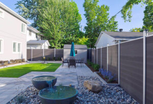 Grey Mecofence WPC composite privacy fence for landscaped backyards, offering premium, moisture-resistant boundary solutions for overseas constructors.