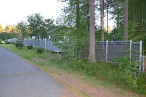 Grey Mecofence WPC composite stepped fence for sloped terrain, offering adaptable installation for rural constructors and overseas bulk orders.
