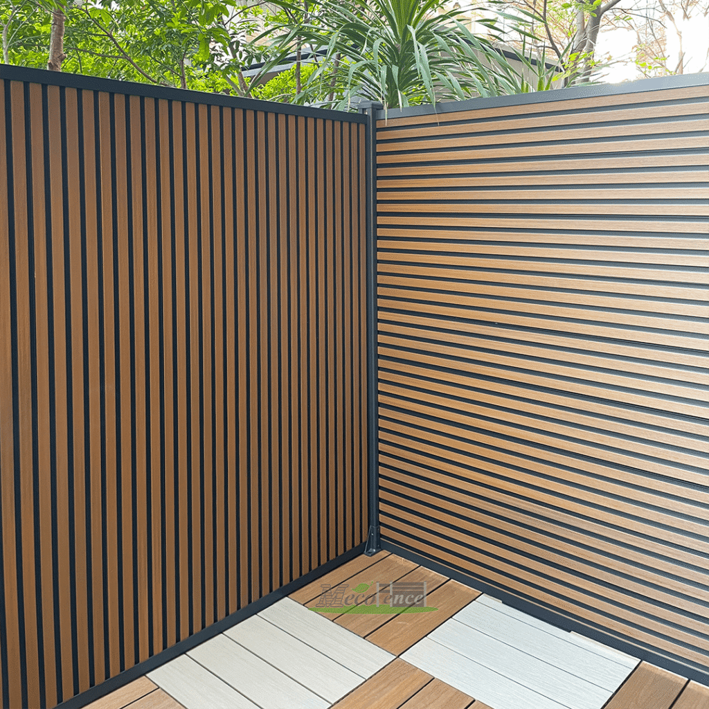 A privacy backyard showcasing the versatility of dual-tone slatted fence panels, featuring both vertical slatted fence sections and horizontal composite fence slats for a stylish, neighbor-friendly boundary.