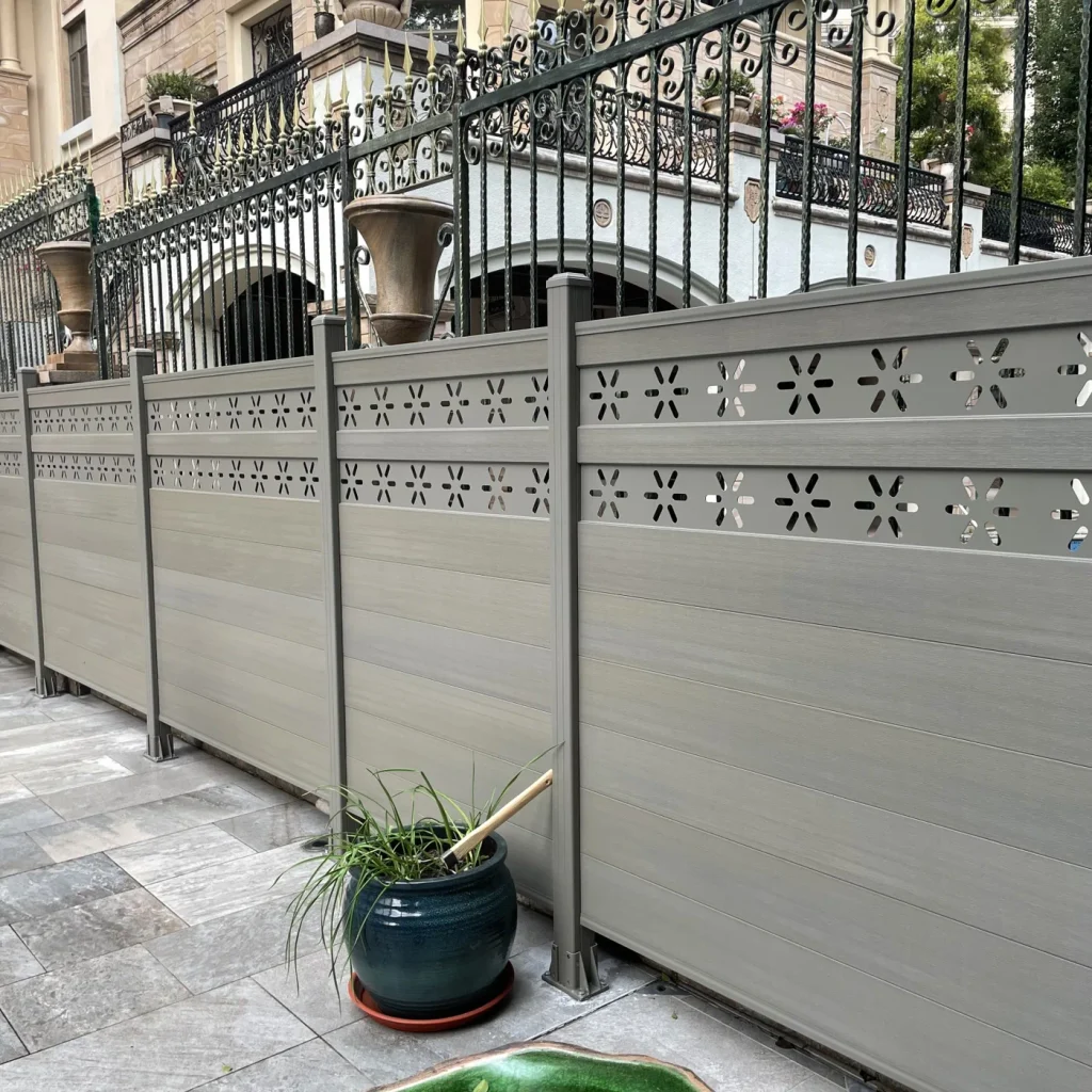 Grey composite fence with black posts and decorative aluminum top screens