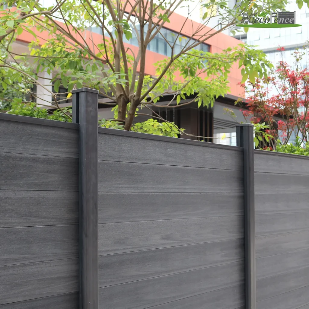 Dark grey privacy composite kit fence with closely fitted boards and colour-matched posts