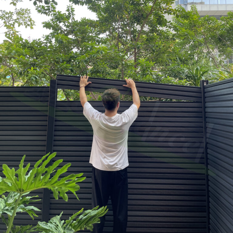 dark grey slat composite fence installation