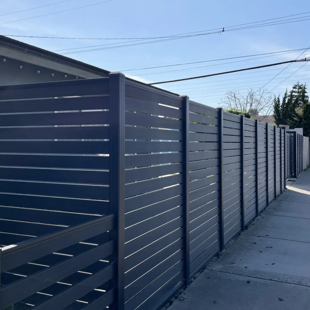 Street frontage with full-trellis composite fence and low ranch-style section