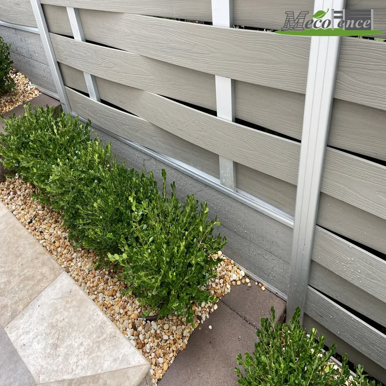 Grey woven composite fence boards woven around vertical aluminium tubes