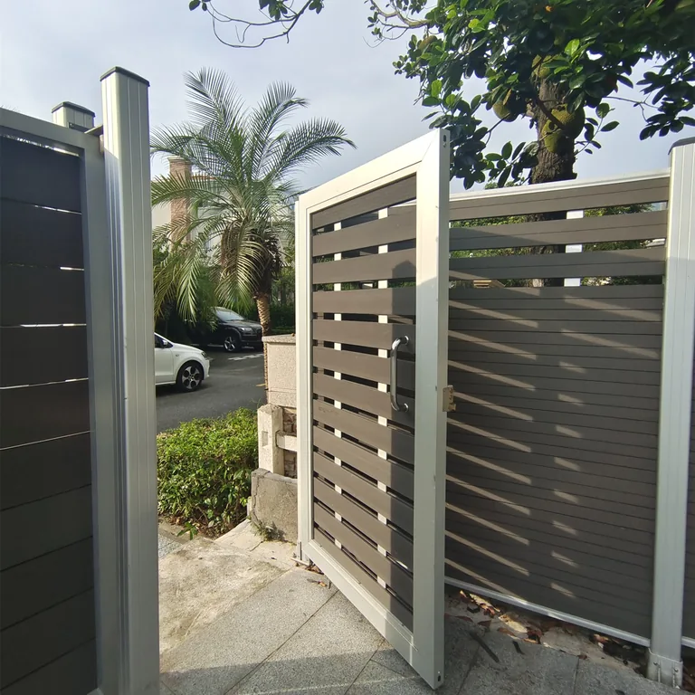 Spaced-board single-leaf composite gate shown open beside a matching fence run