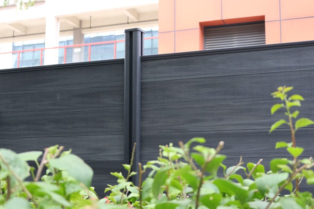 MecoFence Super Kit WPC fence post shown in a Full Privacy configuration with interlocking composite fence boards for a solid, gap-free perimeter.