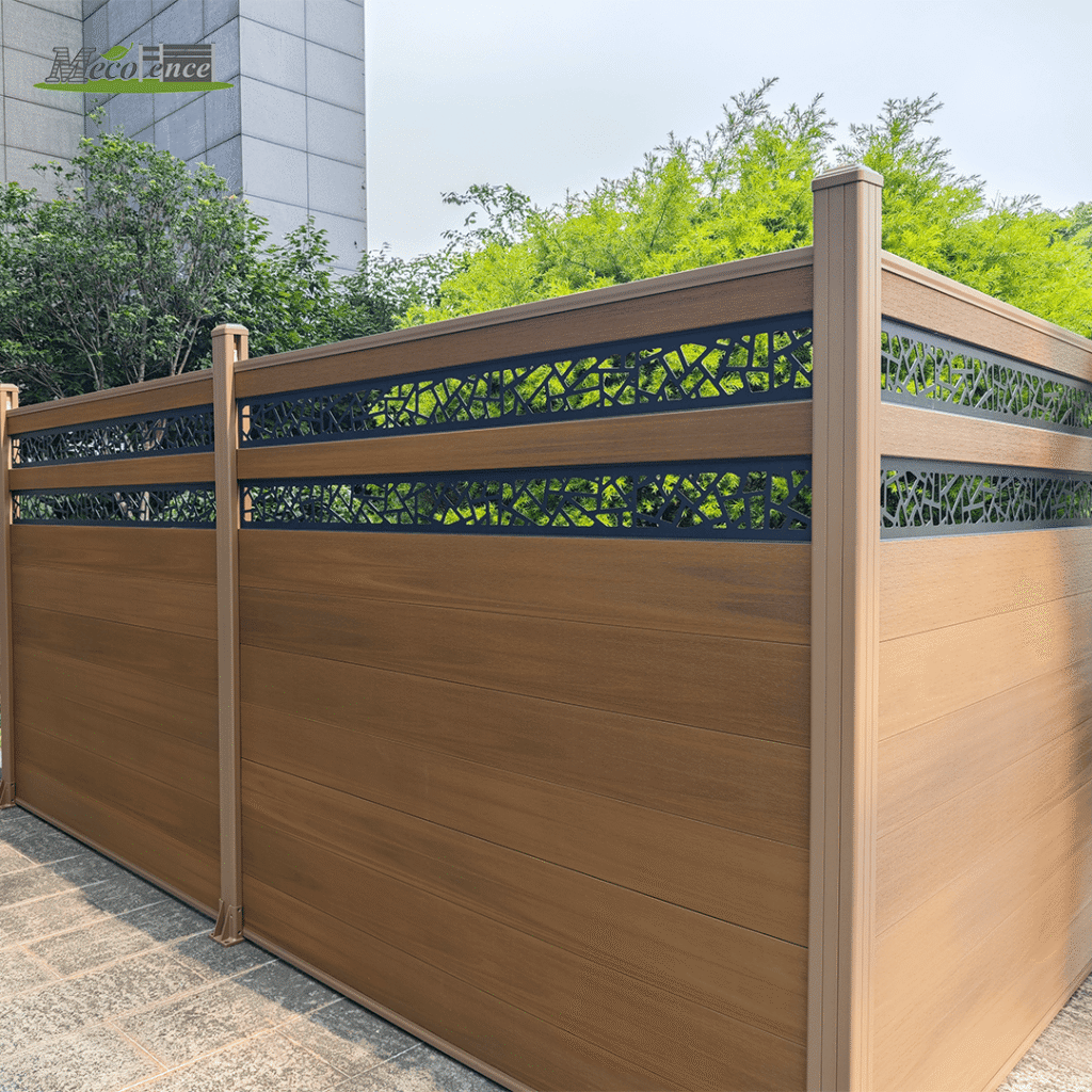 Mecofence 6ft teak composite fence featuring a horizontal wood-grain design and an integrated black aluminum decorative screen with a leaf lattice pattern in a garden setting.