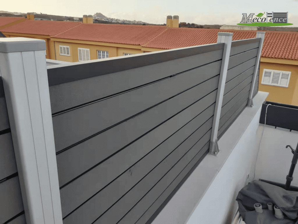 Mecofence 4ft antique composite trellis fence mounted on a white balcony wall to provide privacy for a rooftop outdoor shower and lounge area.