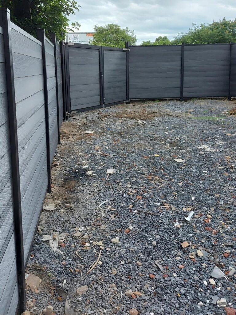 Close-up of the MecoFence Angle Channel Mounting adapter, designed to handle irregular fence angles. This hardware allows contractors to install straight composite panels in short segments to