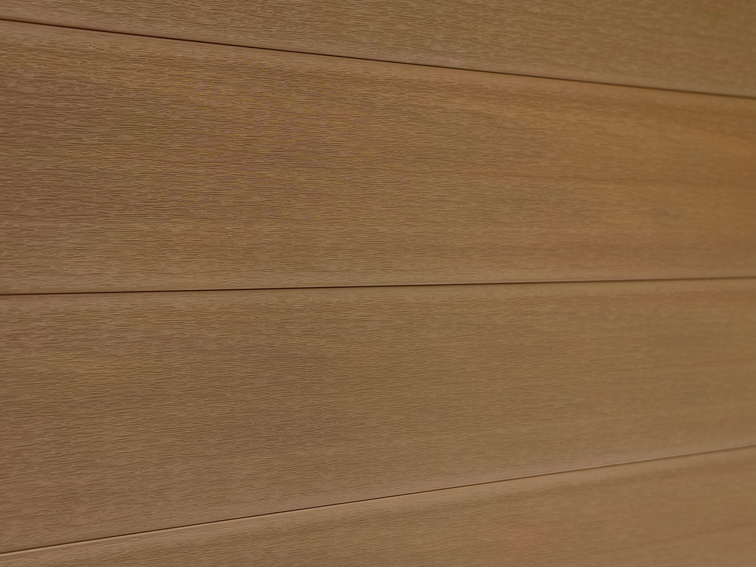 Mecofence natural teak composite fencing color option with wood grain texture.
