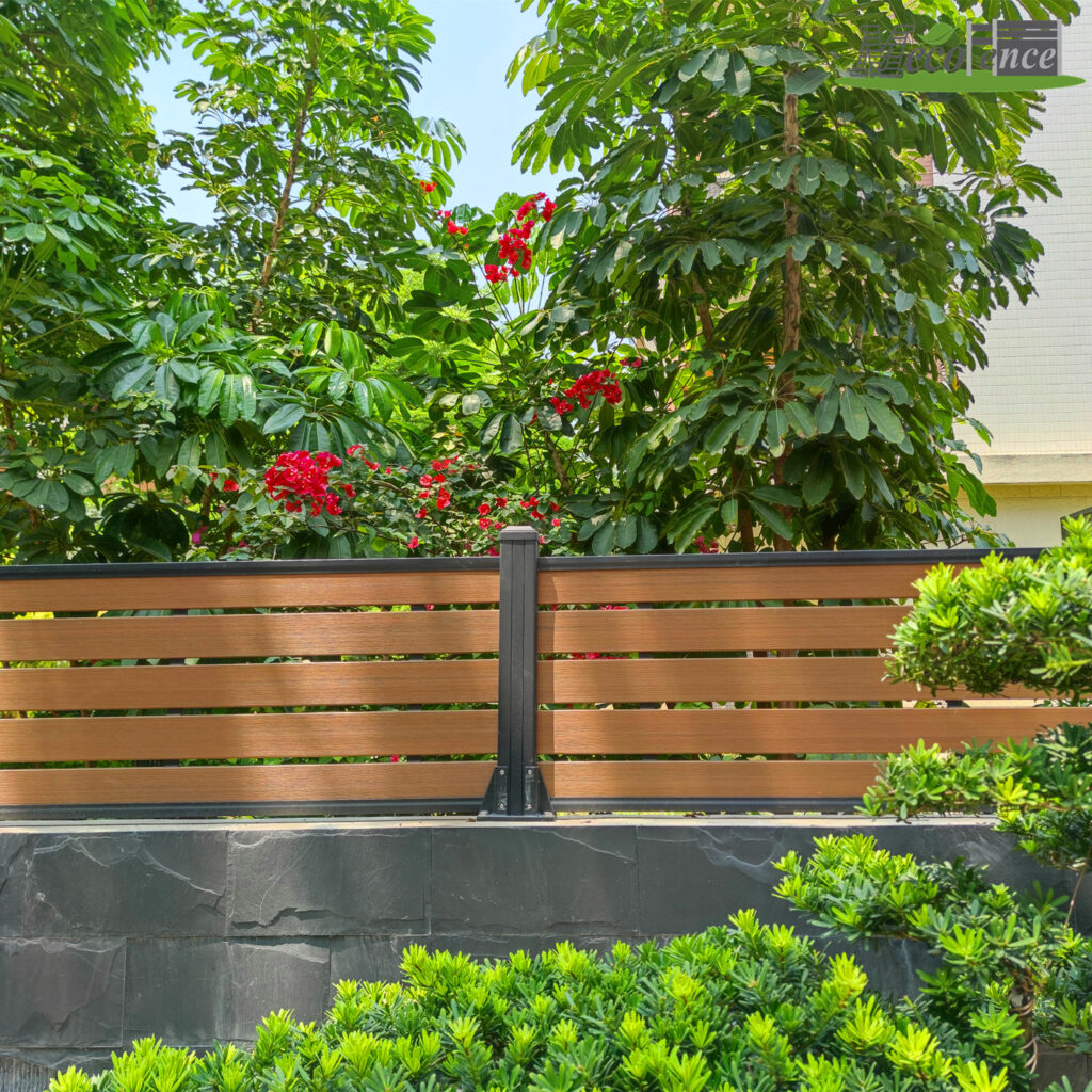 MECOFENCE WPC composite fence boards for trellis in Teak colour – horizontal slat installation with black aluminium posts, garden plants visible through full-interval spacing