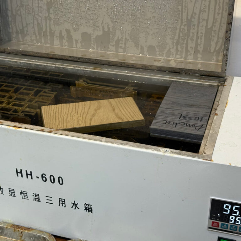 Boiling water immersion test on MecoFence composite fence panel, verifying 100% waterproof and anti-swelling performance for extreme weather