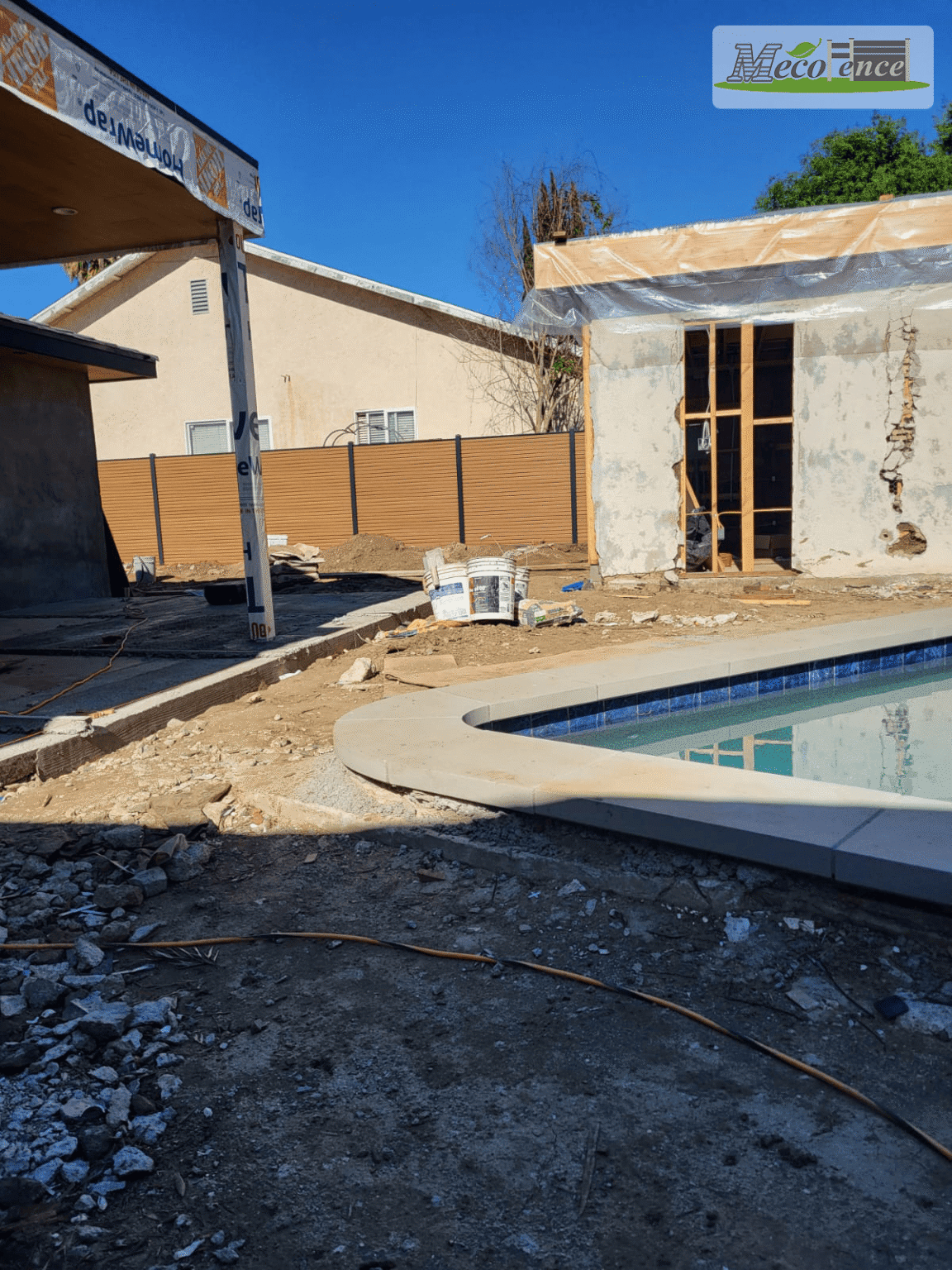California pool house under construction with composite privacy fence visible behind
