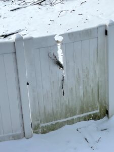Cracked vinyl fence post caused by cold weather — common PVC fencing durability problem