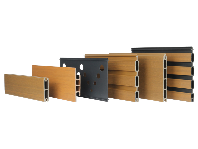 Lineup of MecoFence composite fence board profiles — solid, wide privacy, aluminum carved screen, fluted and hollow-core interlocking boards in teak and dark grey