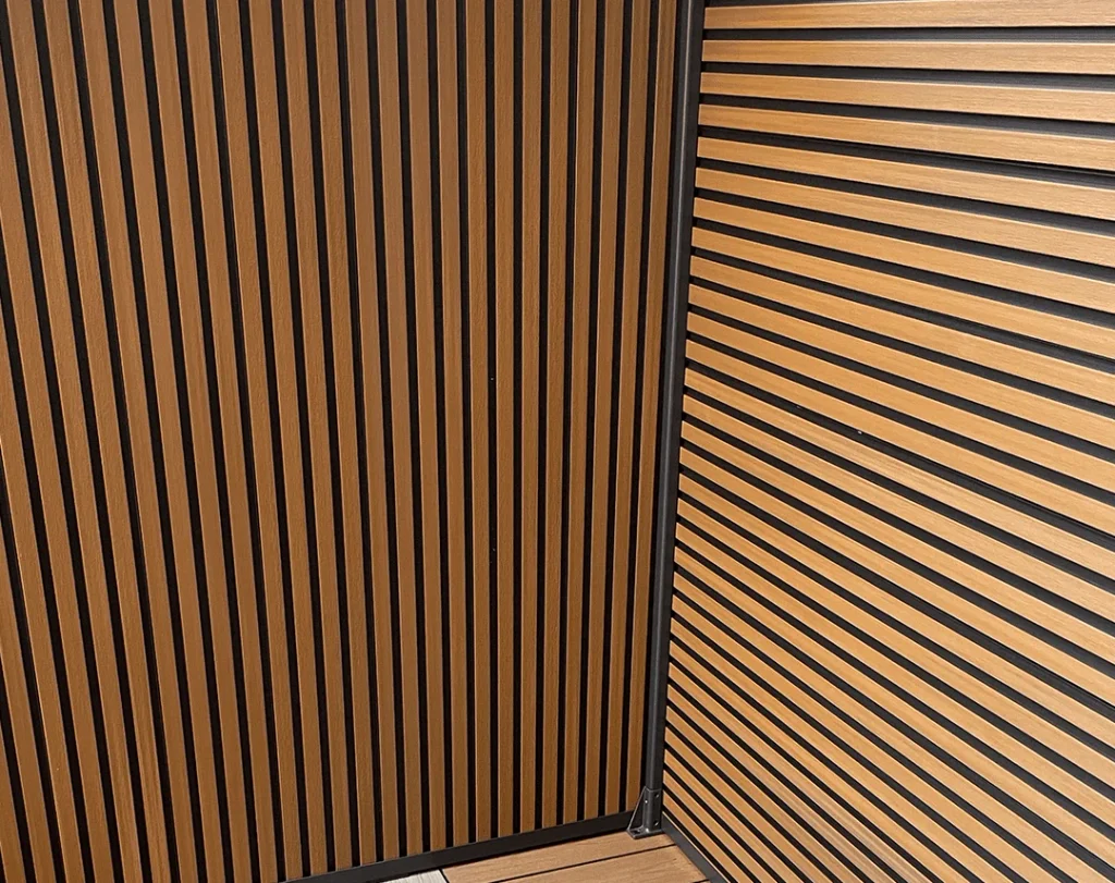 Vertical boards on the left and horizontal boards on the right meeting at a fence corner