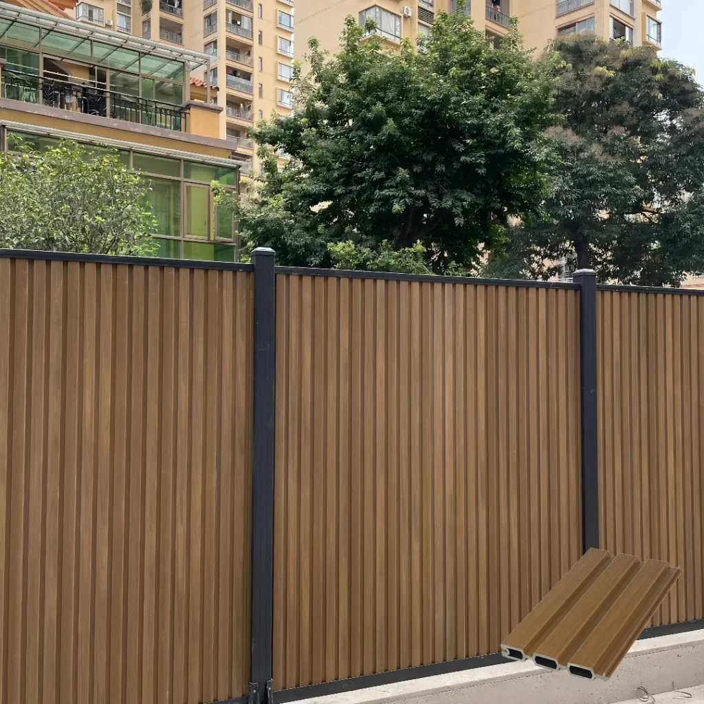 Teak fluted composite fence boards installed vertically for a residential boundary