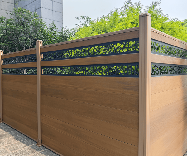 Mecofence 6ft teak composite fence featuring a horizontal wood-grain design and an integrated black aluminum decorative screen with a leaf lattice pattern in a garden setting.