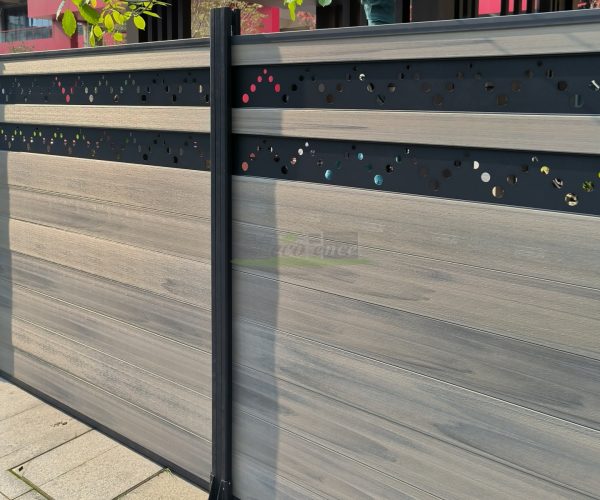 MecoFence carving decorative composite fence panel with laser-cut leaf vein pattern on upper section, casting ornamental shadows on the ground