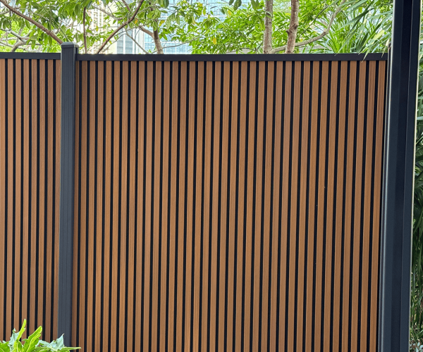 vertical composite fencing installed with heavy-duty black powder-coated aluminum posts for superior weather resistance.